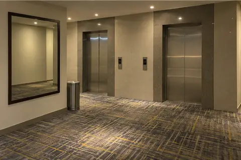 The lift lobby on a guest floor of a Pune hotel at night