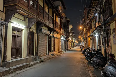 An old peth lane in Pune at night, shutters down